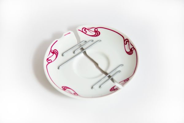 Tea saucer repaired by STUDIO DAM using Juci, a Chinese porcelain mending technique that uses metal staples